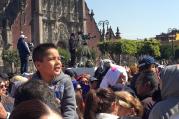 Watching Francis. A young boy with the crowd in Mexico City's historic Zocalo watches Pope Francis on a jumbo screen as he speaks to Mexico's bishops on Feb. 13. (Photo by Kevin Clarke)