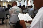 A man reads from a missal during Mass in a makeshift Catholic chapel in a village outside Tianjin, China, July 2012.