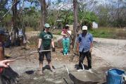 BUILDING COMMUNITY. The author, left, works on a house.