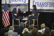 House Speaker Paul Ryan, R-Wis., talks with Heather Reynolds, CEO and president of Catholic Charities Fort Worth, Texas, during a town hall meeting on poverty April 3 at the charity's Fort Worth campus.