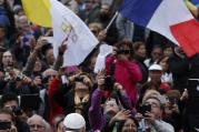 Pope Francis passes the flags of the Vatican and France as he arrives to lead his general audience in St. Peter's Square at the Vatican, Nov. 18 (CNS photo/Paul Haring).