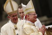 New Archbishop Peter B. Wells, a native of Tulsa, Oklahoma, right, smiles during his ordination to the episcopate by Pope Francis in St. Peter's Basilica at the Vatican, March 19. 