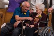 Sylvester and Angela Geurts exchange the sign of peace during Mass Oct. 2 at St. Katharine Drexel Church in Kaukauna, Wis. The Geurts are celebrating their 70th anniversary this year. (CNS photo/Sam Lucero, The Compass)