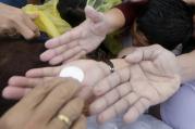 Pilgrims reach to receive Communion as Pope Francis celebrates Mass Jan. 18 in Manila, Philippines (CNS photo/Francis Maalasig, EPA).