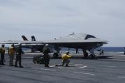 Crew prepares to launch pilot-less drone combat aircraft from aircraft carrier in Atlantic Ocean off coast of Virginia, May 21, 2013.