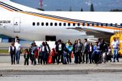 Four mothers and 10 children land in Guatemala City, Guatemala, Jan. 6 after being deported from the United States (CNS/photo/Esteban Biba, EPA).