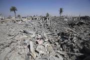 Palestinians on Aug. 1 walking in the rubble of destroyed houses in Khan Younis, hit by Israeli shelling and airstrikes.