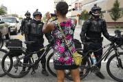 A demonstrator takes a picture of the police line during the Shut Down Trump & the RNC protest on July 17, in Cleveland. (AP Photo/John Minchillo)