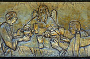 Supper at Emmaus. Jesus and two disciples sit around the table and share a meal.
