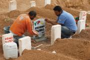 ￼FINAL REST. Men place a headstone at the grave of Seydo Mehmud Cumo, 44, at a cemetery in Suruc, Turkey, Oct. 11. Cumo was a Syrian Kurdish fighter killed in clashes with Islamic State militants in Kobani, Syria.