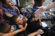 CRIES FOR HOME. Syrian refugee children in front of Macedonian riot police at the Greek-Macedonian border, near the village of Idomeni, Greece, Aug. 21. 