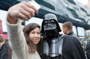 STAR WARS SELFIE. Ukrainian woman poses with a person dressed as Darth Vader.