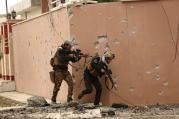 Soldiers with Iraq's elite counterterrorism forces secure houses and streets during fighting against Islamic State militants to regain control of the eastern neighborhoods of Mosul, Iraq, Tuesday, Dec. 13, 2016. (AP Photo/Hadi Mizban)
