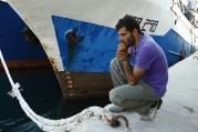Syrian migrant attends commemorative service at harbor in Malta for immigrants who lost their lives at sea.