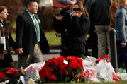 People walk past a memorial site following Jessica Rekos' funeral Mass at St. Rose of Lima Church in Newtown, Conn., Dec. 18. Photo: CNS.