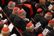 Australian Cardinal George Pell, prefect of the Vatican Secretariat for the Economy, center, participates in prayer at the start of a session of the Synod of Bishops on the family at the Vatican, Oct. 15 (CNS photo/Paul Haring).