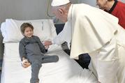 Pope Francis greets a patient during an unannounced visit Jan. 5 to children at the Palidoro Bambino Gesu Hospital, in Fiumicino, outside Rome. (CNS photo/L'Osservatore Romano)