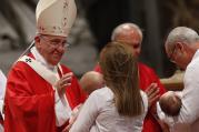 Pope Francis blesses babies as a couple present offertory gifts during the celebration of Mass marking the feast of Sts. Peter and Paul in St. Peter's Basilica at the Vatican June 29.