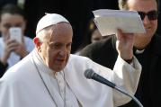 Pope Francis holds up letters he received from young people during a visit to St. Mary Mother of the Redeemer Parish on the outskirts of Rome March 8. (CNS photo/Paul Haring)