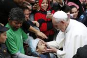 Pope Francis blesses boy during visit to slum complex in Brazil, July 25 (CNS Photo / Paul Haring)