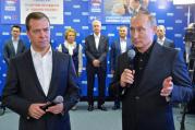 Russian President Vladimir Putin, right, and Russian Prime Minister Dmitry Medvedev, left, speak at United Party's election headquarters in Moscow, Russia, Sunday, Sept. 18, 2016.