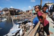 STORM WARNING. A girl reviews the devastated waterfront of Guiuan, Philippines, on Nov. 19. Did global warming contribute to the ferocity of Typhoon Haiyan?