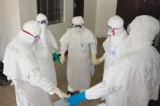 CIRCLE OF LIFE. Health workers at prayer as they start their shift in Monrovia, Liberia, in September.