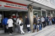 PEOPLE STAND IN LINE AT GOVERNMENT EMPLOYMENT OFFICE IN SPAIN