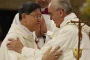 Pope Francis greets Cardinal Luis Antonio Tagle of Manila, Philippines, at the sign of peace while celebrating Mass at the city's Cathedral of the Immaculate Conception on Jan. 16. (CNS photo/Paul Haring)