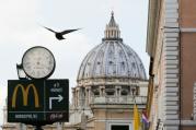 A sign in front of St. Peter's Basilica points to the newest McDonald's restaurant in Rome, next to the Vatican. Jan. 3, 2017. Photo courtesy of Reuters/Alessandro Bianchi