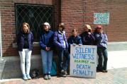 Death penalty opponents stood in front of the U.S. District Court in Boston on Monday.