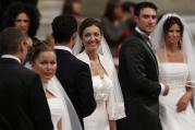 Newly married couples react after exchanging vows in St. Peter’s Basilica at the Vatican Sept. 14, 2014. Among those married were couples who already had children or have lived together before marriage. (CNS photo/Paul Haring)