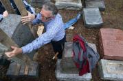 Philip Weiss of Rosenbloom Monument Co. reset headstones at Chesed Shel Emeth Cemetery in University City on Feb. 21, 2017, where almost 200 gravestones were vandalized over the weekend (photo: Robert Cohen/St. Louis Post-Dispatch).