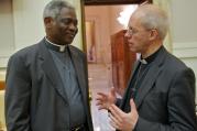 Cardinal Peter Turkson, president of the Pontifical Council for Justice and Peace, talks with Anglican Archbishop Justin Welby of Canterbury, spiritual leader of the Anglican Communion, after a Vatican meeting on human trafficking June 15.
