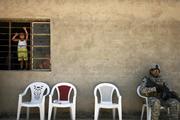 Iraqi children look out a window as local tribe leaders meet with Iraqi and U.S. security forces near Muqtadiyah in Iraq's Diyala province in 2008. (CNS photo/Damir Sagolj, Reuters) 