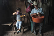 A girl eats her meal next to a relative shucking corn in Terrabona, Nicaragua. (CNS photo/Oswaldo Rivas, Reuters)