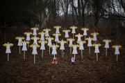 Twenty-seven wooden painted angels created by Eric Mueller are displayed outside his home in Newtown, Conn. (CNS photos/Mike Segar, Reuters). 