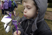 Pre-K student Patrick Meade plays with a pinwheel April 9 as students of St. Thecla School in Chicago mark National Child Abuse Prevention Month.