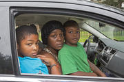 Homeless family living out of car pose for photo in Detroit. (CNS photo/Jim West) 