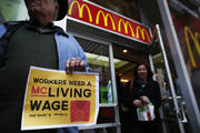 Woman exits McDonald's while fast-food workers protest for higher wages in New York (CNS photo/Eduardo Munoz, Reuters) 