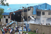 People gather near the damaged Shalom Church after deadly bombing in 2012 in the northern Nigerian city of Kaduna. (CNS photo/Stringer via Reuters) 