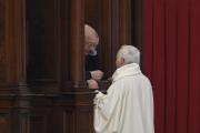 Priest hears confession of clergy member in St. Peter's Basilica at Vatican. (CNS photo/Paul Haring)