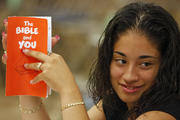  A young woman holds a Bible study guide while attending a New Testament class at St. Luke Church in Brentwood, N.Y. (CNS photo/Gregory A. Shemitz)