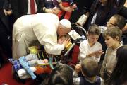 Pope Francis kisses a disabled child during a visit to the parish of Santa Maria dell'Orazione on the outskirts of Rome March 16. (CNS photo/Stefano Rellandini, pool via Reuters)