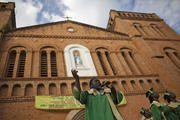 A member of a choir sings a song of reconciliation and peace in front of a Catholic cathedral during the last day of Easter celebrations in Bangui, Central African Republic, April 21. (CNS photo/Siegfried Modola, Reuters)