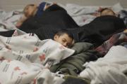 Detainees sleep in holding cell at U.S. Customs and Border Protection processing facility in Brownsville, Texas.