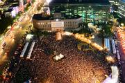 People gather at the Seoul Plaza in front of the City Hall in downtown Seoul July 24. Asian Youth Day will coincide with Pope Francis' visit to that country, where he is scheduled to beatify 124 Korean martyrs.