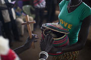 South Sudanese woman gives alms during Mass in camp for displaced people. (CNS photo/Jim Lopez, EPA)