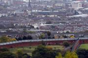 A section of the Peace Wall that divides Catholic and Protestant communities cuts its way through West Belfast, Northern Ireland. (CNS photo/Cathal McNaughton, Reuters)