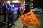 Protester faces line of police during Los Angeles demonstration following Missouri grand jury decision on shooting of black teen.